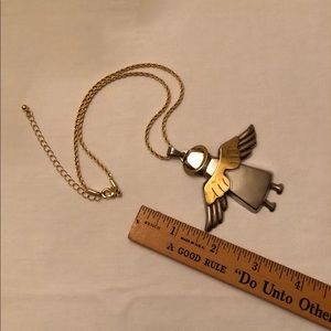 Angel pendant with gold tone chain. Two tone metal